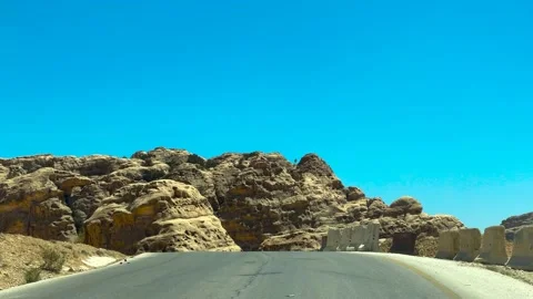 Driving down a desolate Arabian Desert country road Stock Footage 237809162