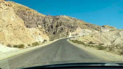 Driving down a desolate Jordan Desert country road Stock Footage 237808979