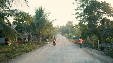 Driving Down a Dirt Road in a Third World Asian Country Stock Footage 128656524
