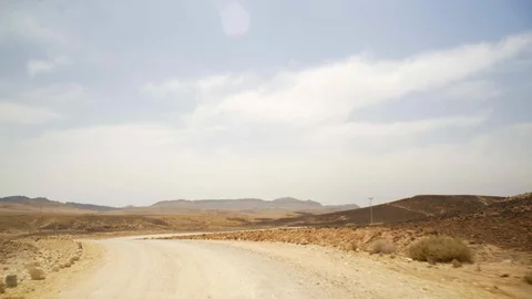 Driving down empty dirt road in the desert, Makhtesh Ramon Crater, Israel Stock Footage 87403205