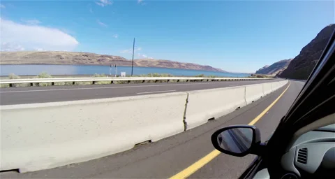 Driving down a highway along a river Stock Footage 51737911