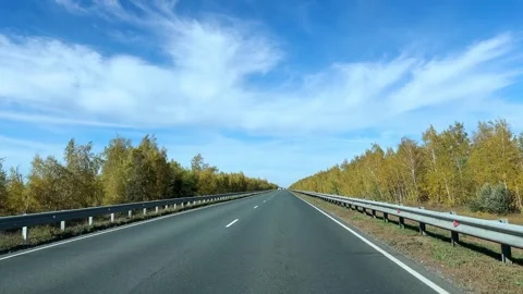 Driving down a highway lined with autumn trees. Stock Footage 286423476