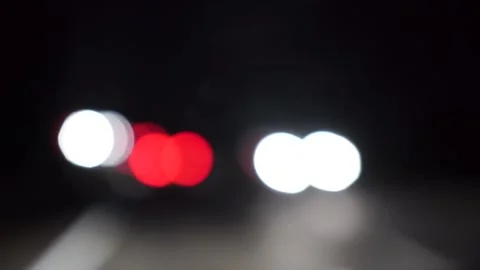 Driving down the highway at night we see blurry red and white bokeh lights Stock Footage 136501458