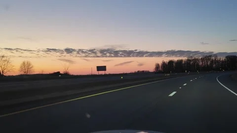 Driving Down Highway at Sunset With Curved Road and Landscape Stock Footage 332381960