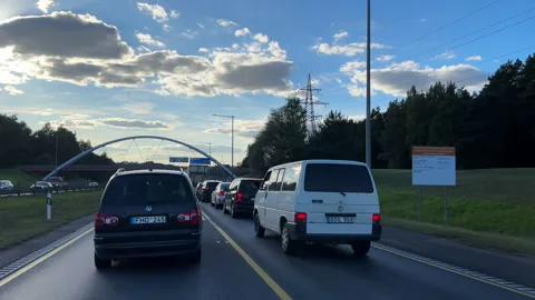 Driving down the hill on motorway in Lithuania. Slow traffic due to roadworks Vídeos de archivo 252087239