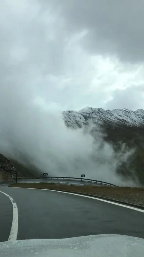 Driving down ice-covered hairpin turns in Swiss Alps. Stock Footage 329227591