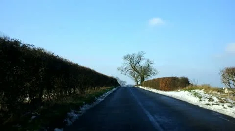 Driving down a long straight rural road in winter Stock Footage 10748279