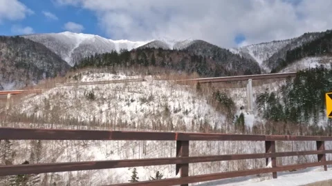 Driving down a mountain pass with bridge and sky above Stock Footage 265637736