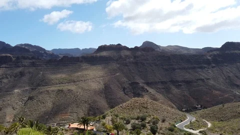 Driving down a mountain road while filming sideways 動画素材 103213522