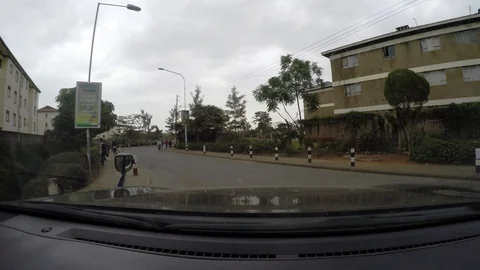 Driving down a nice road in Africa and passing a school bus Video stock 106908814