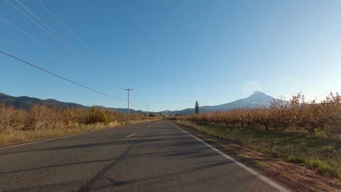 Driving Down Open Road, On A Sunny Day Through Farm Land, Mt. Hood In Distance Stock Footage 120716487