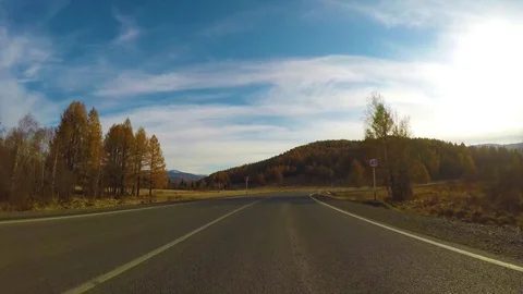 Driving down a quiet rural highway during the day in autumn. Stock Footage 81324779