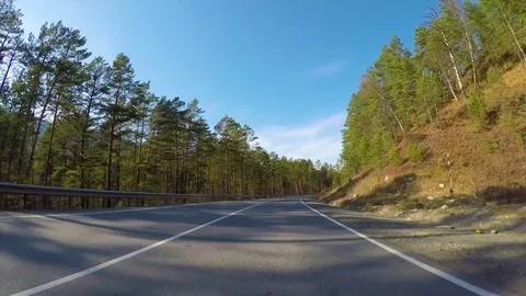 Driving down a quiet rural highway during the day in autumn. Stock Footage 82640930