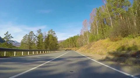 Driving down a quiet rural highway during the day in autumn. Stock Footage 82642576