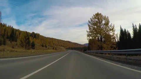Driving down a quiet rural highway during the day in autumn. Stock Footage 83087094
