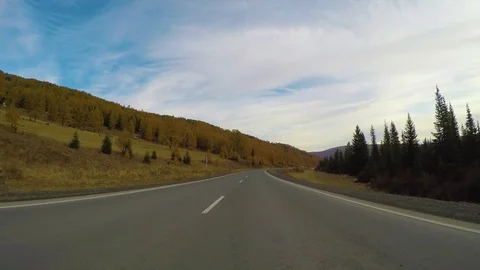 Driving down a quiet rural highway during the day in autumn. Stock Footage 83090107