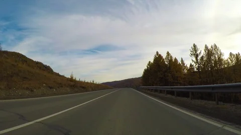 Driving down a quiet rural highway during the day in autumn. Stock Footage 83101522