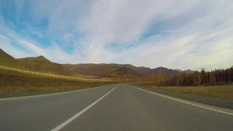 Driving down a quiet rural highway during the day in autumn. Stock Footage 84864541