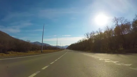Driving down a quiet rural highway during the day in autumn. Stock Footage 84873870