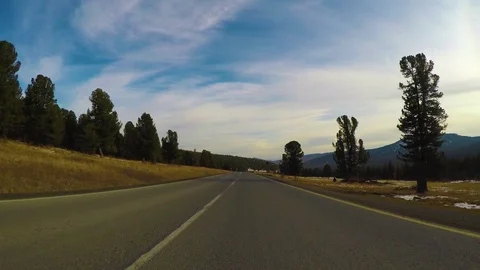 Driving down a quiet rural highway during the day in autumn. Stock Footage 84876399