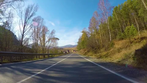 Driving down a quiet rural highway during the day in autumn. Stock Footage 84894084