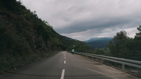 Driving down a road cloudy day Stock Footage 129749132