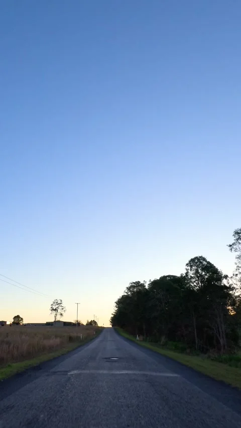 Driving Down a Rural Asphalt Road at Sunset in Australia Stock Footage 340374070