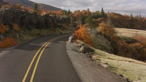Driving down scenic winding road in fall.  Shot with Cineflex gimbal and RED 8K Stock Footage 125335906