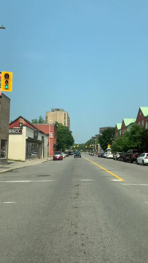 Driving down small city street Stock Footage 162860882