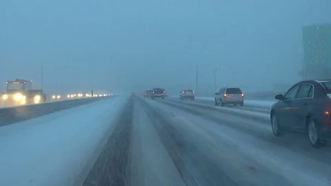 Driving down snow covered highway at rush hour in Canada. Vídeos de archivo 76237300