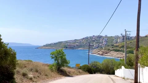 Driving down on a steep road to the sea Stock Footage 241835471