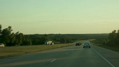 Driving down a straight road at dusk  Stock Footage 79851458