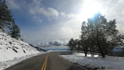 Driving down on a winding road on a winter day Stock Footage 133469210