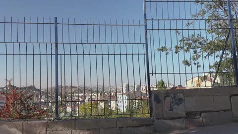 Driving downhill, side city view behind the fences Stock Footage 253894411