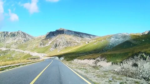 Driving downhill on a winding road in the mountains Stock Footage