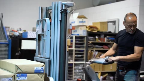 Driving electric fork lifter inside a warehouse working class labor concept 動画素材 263541619