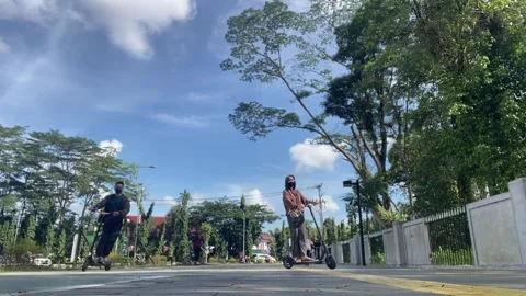 Driving electric scooter Stock Footage 292976398