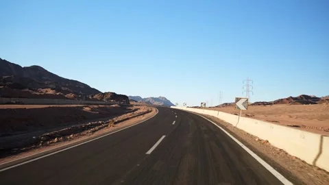 Driving on the empty asphalt highway in the desert with road surface marking Stock Footage 251740133