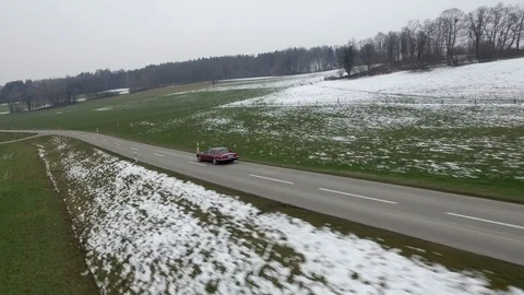 Driving on an empty asphalt road through the wheat fields with snow and fog. Stock Footage 120959482