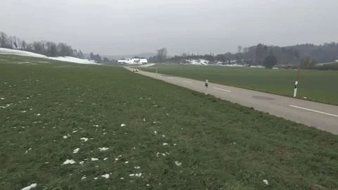 Driving on an empty asphalt road through the wheat fields with snow and fog. Stock Footage 120959501