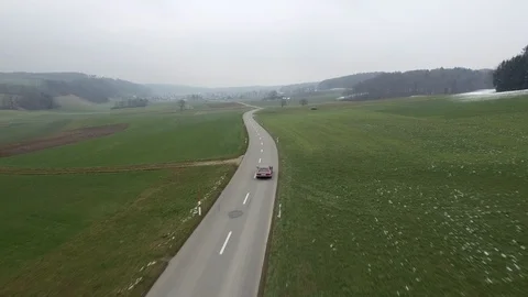 Driving on an empty asphalt road through the wheat fields with snow and fog. Stock Footage 120959755