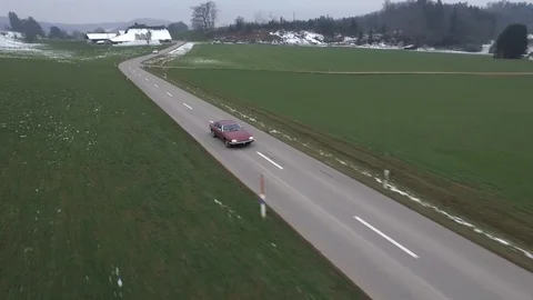 Driving on an empty asphalt road through the wheat fields with snow and fog. Stock Footage 120959937