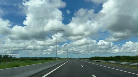 Driving on an empty highway under blue cloudy sky in Georgia Vídeo Stock 335615420