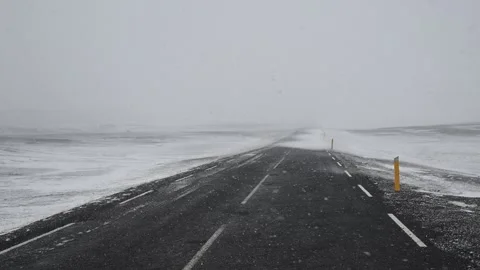Driving on an empty road during a heavy snowstorm in iceland Stock Footage 334816148