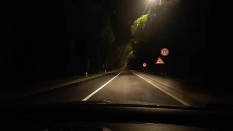 Driving on an empty road full of road signs at night Stock Footage 303933724