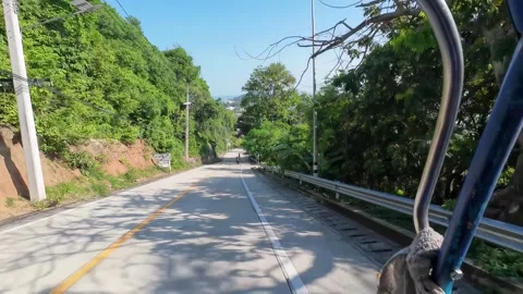 Driving Empty Road with Rock Cliff and Tropical Trees 库存影片 341368606