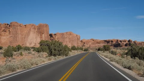 Driving On Empty Road Through Amazing Arches National Park In Utah On Sunny Day Stock Footage 119902485