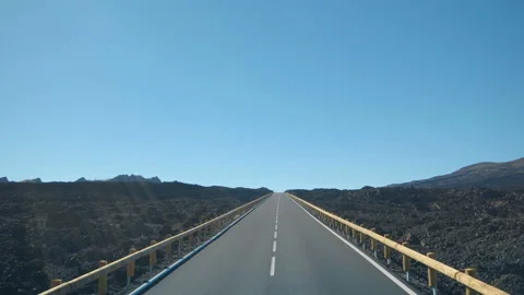 Driving on an empty road through a volcanic landscape from the black lava Stock-Footage 101304390