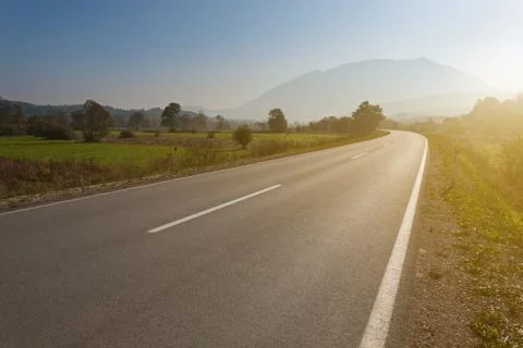 Driving on an empty road towards the mountain Stock Photos