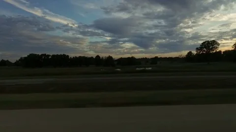 Driving by Farm Fields at Sunset Side View Stock Footage 80776924